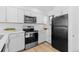 Modern kitchen boasts stainless steel appliances, sleek white cabinetry, and ample counter space for easy meal preparation at 1818 S Quebec Way # 2-3, Denver, CO 80231