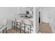 Contemporary kitchen with bar seating, stainless steel appliances, and seamless connectivity to the adjacent dining and living areas at 1818 S Quebec Way # 2-3, Denver, CO 80231
