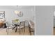 Bright dining area featuring a glass table, stylish chairs, and contemporary lighting, connecting seamlessly to the kitchen at 1818 S Quebec Way # 2-3, Denver, CO 80231