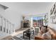 Comfortable living room features a brick fireplace, plush seating, and sliding glass doors that let in plenty of natural light at 1818 S Quebec Way # 2-3, Denver, CO 80231