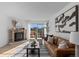 Inviting living room with a cozy fireplace, comfortable seating, and large windows that offer a view to the outdoor scenery at 1818 S Quebec Way # 2-3, Denver, CO 80231