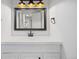 Bright bathroom features a modern vanity with a framed mirror and stylish lighting fixtures for a luxurious feel at 2700 S Holly St # 100, Denver, CO 80222