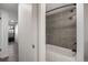 Sleek bathroom showcases modern shower with gray tiling and white tub providing a modern and comfortable bathing experience at 2700 S Holly St # 100, Denver, CO 80222