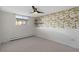 Comfortable bedroom features neutral carpeting, ample wall space, and a window allowing for plenty of natural light at 2700 S Holly St # 100, Denver, CO 80222