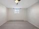 Bedroom features neutral carpet, walls, and ceiling with a ceiling fan and a window for natural light at 2700 S Holly St # 100, Denver, CO 80222