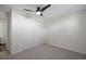 This bedroom features neutral walls, grey carpet, ceiling fan, and a double door closet at 2700 S Holly St # 100, Denver, CO 80222