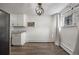 A modern kitchen with white cabinets and gray countertops featuring stylish hardware and contemporary appliances at 2700 S Holly St # 100, Denver, CO 80222