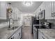 Modern kitchen featuring white cabinets, stainless steel appliances, and a view to breakfast nook at 2700 S Holly St # 100, Denver, CO 80222