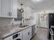 Modern kitchen featuring white cabinets, stainless steel appliances, faucet and sink at 2700 S Holly St # 100, Denver, CO 80222