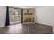 View of the sunlit living room, fireplace, and sliding glass doors leading to an outdoor space at 2700 S Holly St # 100, Denver, CO 80222