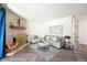 Bright living room with fireplace, grey sofa, herringbone floors, and modern decor at 2700 S Holly St # 100, Denver, CO 80222