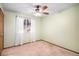Clean and bright bedroom with plush carpet and a view of the backyard at 8304 S Upham Way, Littleton, CO 80128