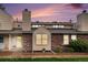 Inviting home exterior featuring brick accents, warm siding, and a well-maintained front lawn at 8304 S Upham Way, Littleton, CO 80128