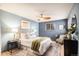 Comfortable main bedroom with a queen bed, soft rug, and soothing blue color palette at 8304 S Upham Way, Littleton, CO 80128