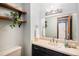 Stylish powder room with floating shelves, modern lighting, and a large mirror at 8304 S Upham Way, Littleton, CO 80128