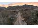 Picturesque aerial view of a quaint town nestled in a mountainous landscape under a colorful sunset sky at 14412 Pansy Loop, Morrison, CO 80465