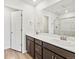 Bathroom with double sink vanity, a large mirror, and a shower behind glass at 14412 Pansy Loop, Morrison, CO 80465