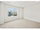Bright bedroom featuring neutral carpet, a large window, and white walls at 14412 Pansy Loop, Morrison, CO 80465