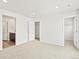 Bedroom view showing multiple entry doors and neutral carpet at 14412 Pansy Loop, Morrison, CO 80465