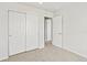 Bedroom with a neutral carpet, closet with sliding doors, and an open doorway leading to an additional room at 14412 Pansy Loop, Morrison, CO 80465