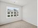 A bright bedroom with a neutral carpet and a large window with blind offering ample natural light at 14412 Pansy Loop, Morrison, CO 80465