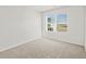 Cozy bedroom featuring neutral carpet, a large window, and white walls at 14412 Pansy Loop, Morrison, CO 80465