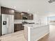 Open kitchen with stainless steel appliances, island, and light wood flooring at 14412 Pansy Loop, Morrison, CO 80465