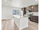 Bright kitchen with large island, stainless steel appliances, and dark cabinets at 14412 Pansy Loop, Morrison, CO 80465