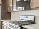 Stainless steel gas cooktop with dark cabinetry and granite counters at 14412 Pansy Loop, Morrison, CO 80465