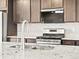 Stainless steel appliances with mosaic backsplash and granite counters at 14412 Pansy Loop, Morrison, CO 80465