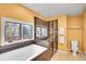 Modern bathroom with soaking tub, separate glass shower, and decorative tile at 30382 Marys Dr, Conifer, CO 80433