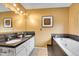 Bathroom with dual vanity sinks and a separate bathtub at 30382 Marys Dr, Conifer, CO 80433