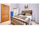 Bedroom with a colorful quilt, wood-framed bed, and a wood-slatted door at 30382 Marys Dr, Conifer, CO 80433