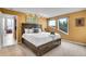 Cozy primary bedroom offers natural lighting with outdoor views and unique wall decor at 30382 Marys Dr, Conifer, CO 80433