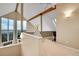 Bonus room with vaulted ceilings, wooden beams, and multiple windows with outside view at 30382 Marys Dr, Conifer, CO 80433