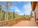 Wide wood deck with mountain views in the background at 30382 Marys Dr, Conifer, CO 80433
