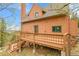 View of the back of the home and its large deck at 30382 Marys Dr, Conifer, CO 80433
