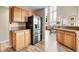 Open concept kitchen features stainless steel refrigerator and modern wood cabinets at 30382 Marys Dr, Conifer, CO 80433