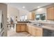 Bright kitchen area with wood cabinets, stone countertops, stainless steel appliances, and an adjacent dining area at 30382 Marys Dr, Conifer, CO 80433