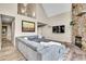 Inviting living room with a large grey sofa, stone fireplace, and a vaulted ceiling at 30382 Marys Dr, Conifer, CO 80433