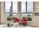Cozy seating area with large windows offering scenic mountain views, adjacent to large grey sectional at 30382 Marys Dr, Conifer, CO 80433