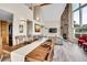 Open-concept living space with dining area, living room with fireplace, and hardwood floors at 30382 Marys Dr, Conifer, CO 80433