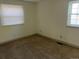 Bright bedroom with neutral carpet, two windows, fresh paint, and electrical outlets at 5543 Victor St, Denver, CO 80239