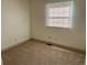 Cozy carpeted bedroom with neutral paint, two windows, fresh paint, and electrical outlets at 5543 Victor St, Denver, CO 80239