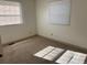 Sunlit bedroom with neutral carpet, two windows, fresh paint, and electrical outlets at 5543 Victor St, Denver, CO 80239