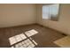 Sunlit bedroom with neutral carpet, a window, fresh paint, and electrical outlets at 5543 Victor St, Denver, CO 80239