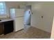 Kitchen with updated appliances, tile floor, and well-lit dining area at 5543 Victor St, Denver, CO 80239