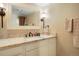 A clean bathroom with a granite vanity top, mirror and towel rack at 6376 S Glencoe Ct, Centennial, CO 80121