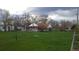 A spacious backyard with lush green grass and a charming single-Gathering home; a perfect outdoor space for relaxation and play at 7170 W Mississippi W Ave, Lakewood, CO 80226