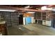 A large unfinished basement with concrete walls, fluorescent lighting, and exposed ceiling beams; offering endless possibilities at 7170 W Mississippi W Ave, Lakewood, CO 80226